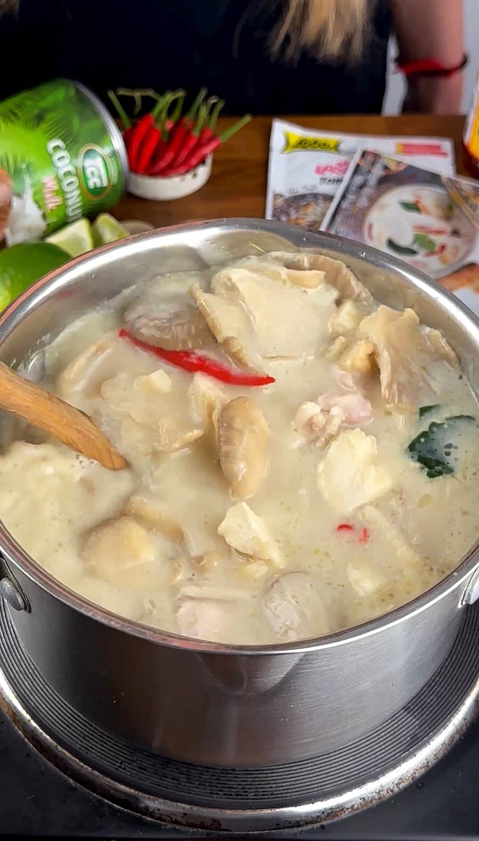 6. Next, add the brown sugar, fish sauce, coconut milk, oyster mushrooms, chicken, torn lime leaves, and crushed chillies. Simmer on low heat until the chicken is fully cooked.