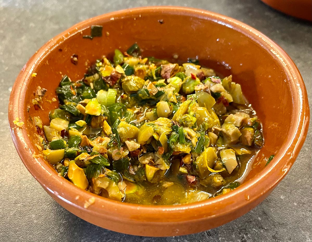 On another small bowl add the chopped pistachios, chopped olives, chopped parsley, chopped spring onions, the chilli flakes (if using), the remaining 1/3 lemon zest, olive oil and salt. Mix well with a spoon.
